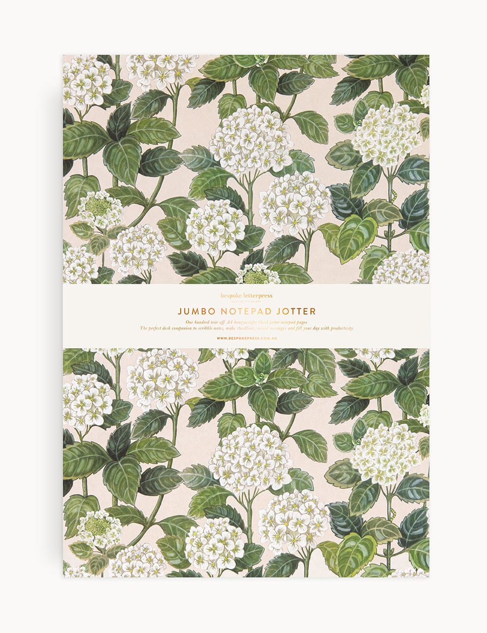 Flat lay of the Bespoke Letterpress Hydrangea Jumbo Notepad Jotter, featuring a botanical illustration of white hydrangea blooms and green foliage on a neutral background, with a gold-foiled bellyband label.