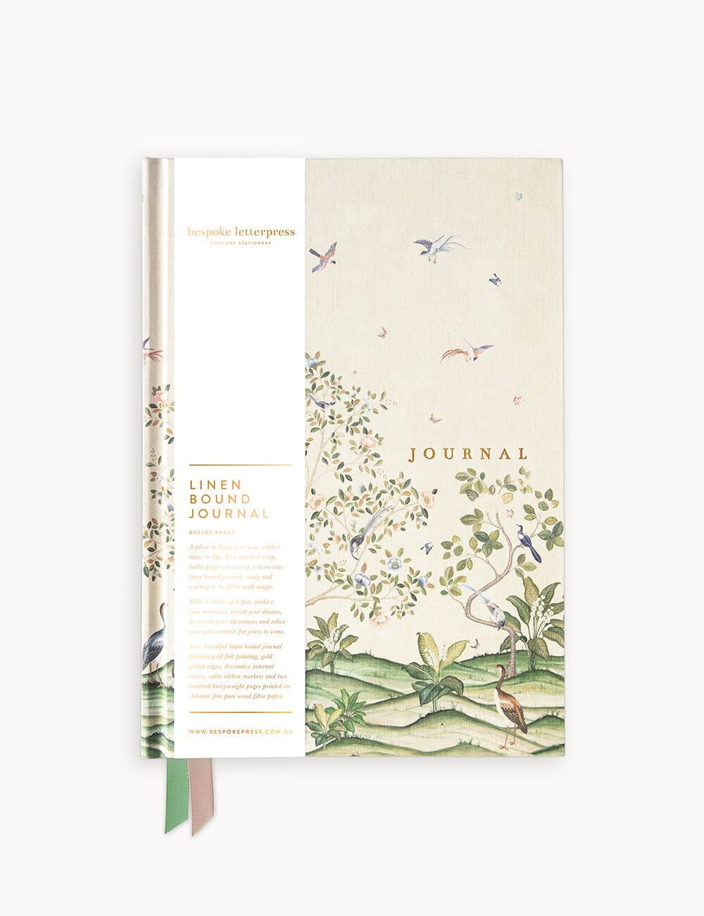 Front view of the Spring Landscape linen-bound bullet journal, featuring a botanical and bird illustration, gold foil title, and branded paper wrap.