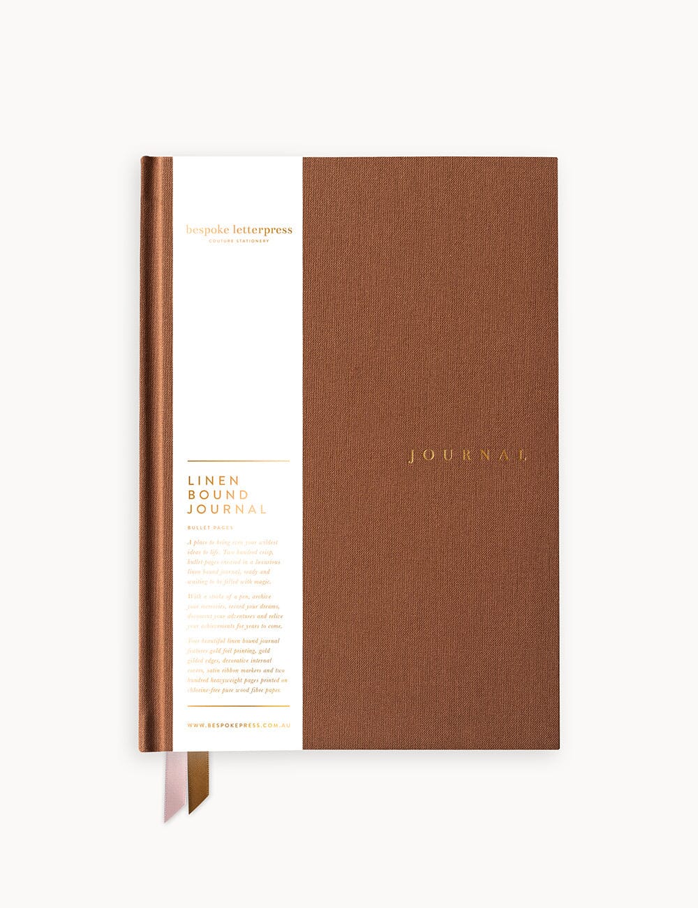 A flat lay of the Mocha Linen-Bound Journal by Bespoke Letterpress, featuring gold foil text on the cover and a white branded paper belly band with ribbon marks peeking out from the bottom.