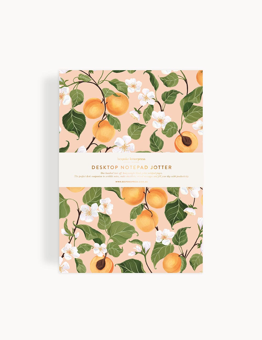 A5 desktop notepad jotter featuring an elegant peach and blossom floral design on a soft blush background, with a gold foil-printed bellyband and refined botanical illustration by Bespoke Letterpress.