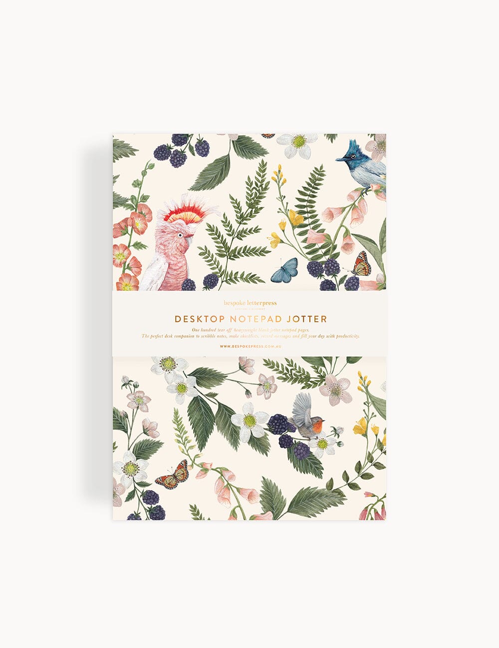Flat lay of Bespoke Letterpress Pink Cockatoo Notepad Jotter featuring a whimsical botanical and bird illustration by Vicky Lastra, with gold foil bellyband on a soft cream background.