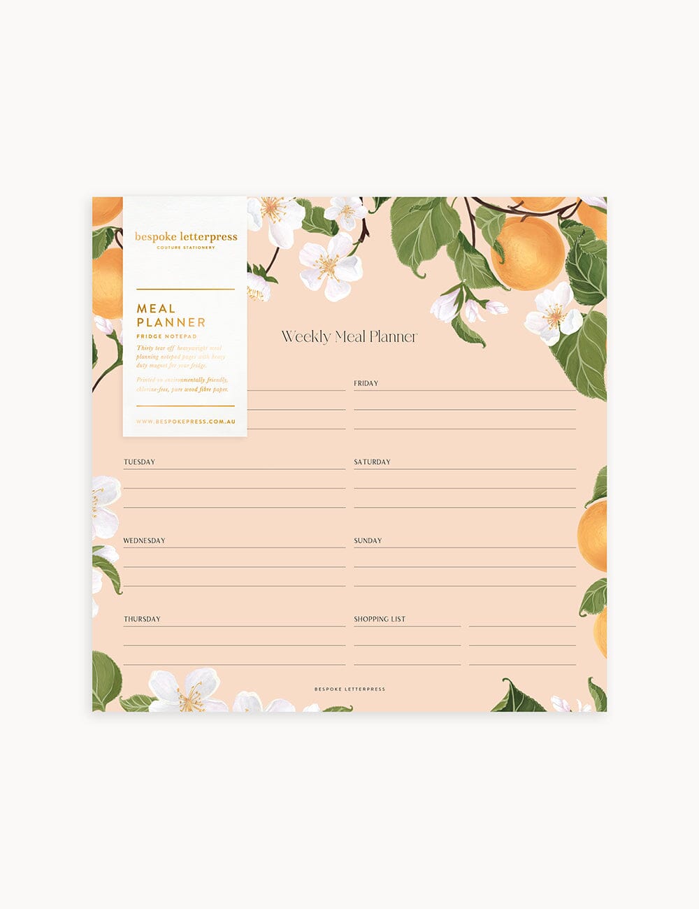 Flat lay of Bespoke Letterpress’ Peaches Meal Planner Notepad featuring illustrated peach branches and white blossoms on a blush background, with a weekly layout and shopping list section.
